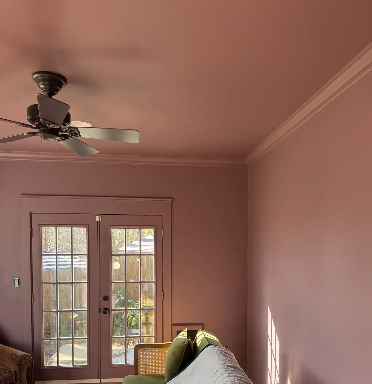 Home office colour washed in dusty rose across walls and ceiling, with white crown moulding and French doors.